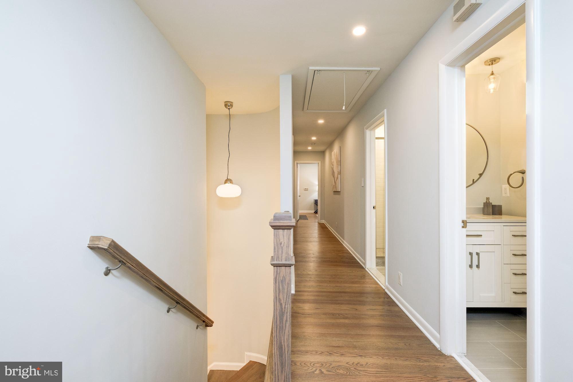 7440 Arrowood Road Bethesda, MD 20817 - Photo 44 of 79 a view of a hallway with wooden floor and staircase