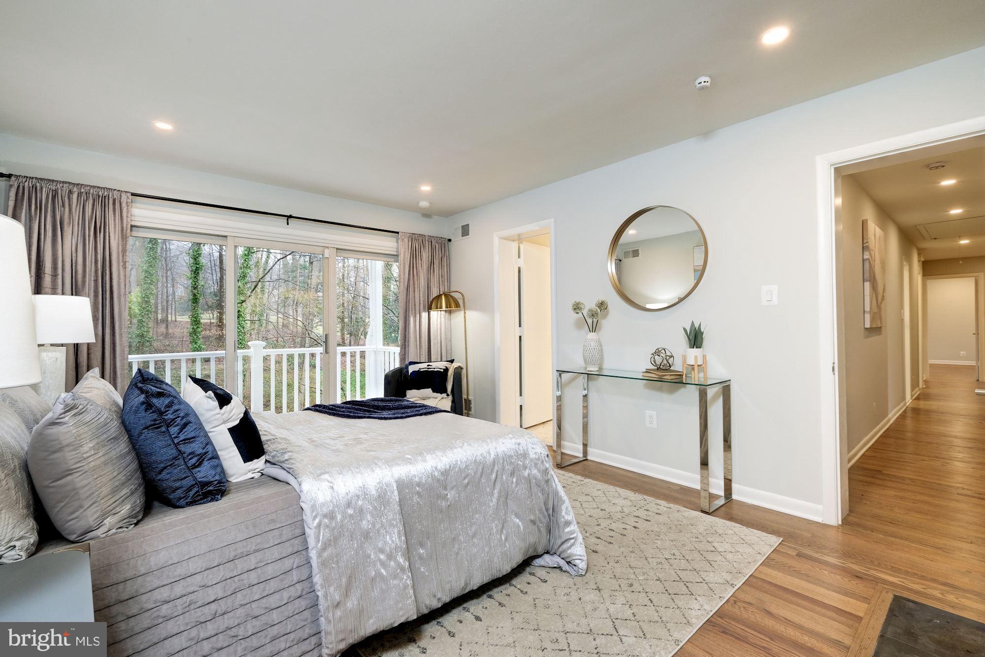 7440 Arrowood Road Bethesda, MD 20817 - Photo 46 of 79 a bed room with a bed a mirror and a large window
