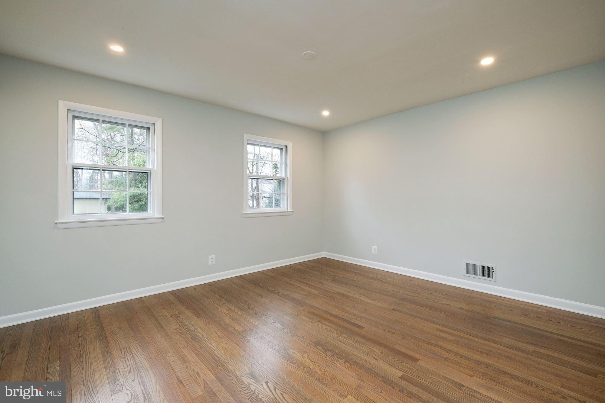7440 Arrowood Road Bethesda, MD 20817 - Photo 56 of 79 an empty room with wooden floor and windows