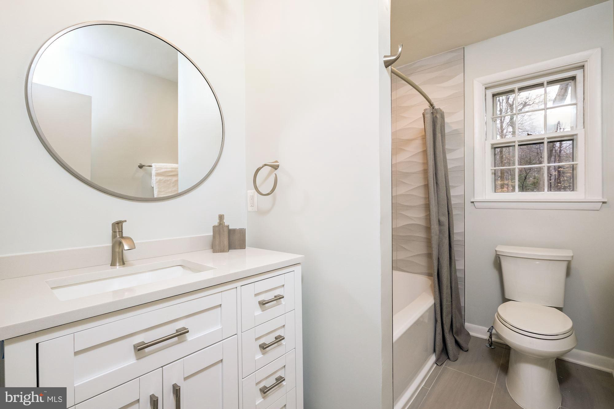 7440 Arrowood Road Bethesda, MD 20817 - Photo 59 of 79 a bathroom with a sink a toilet and a mirror