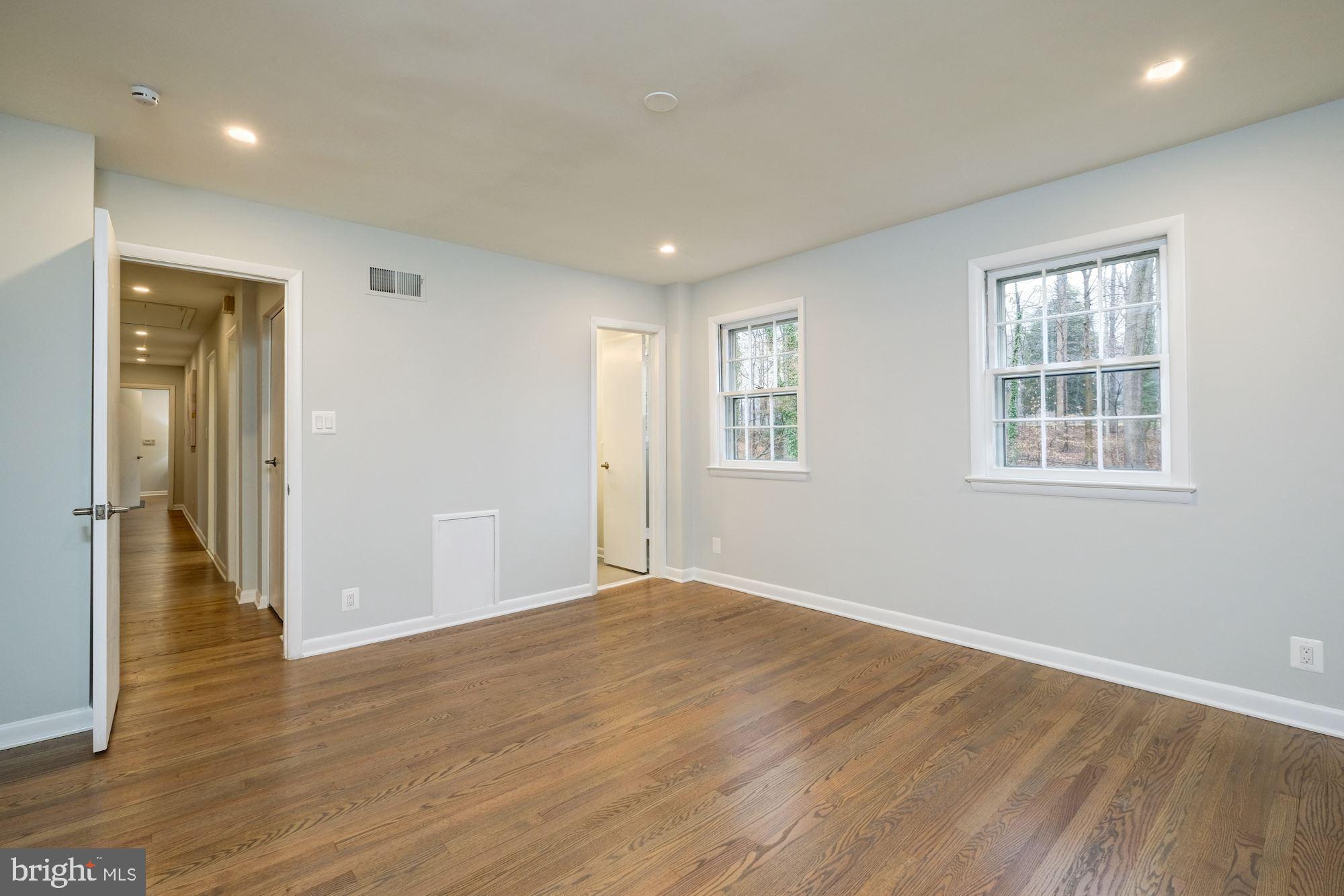 7440 Arrowood Road Bethesda, MD 20817 - Photo 60 of 79 a view of an empty room with wooden floor and a window