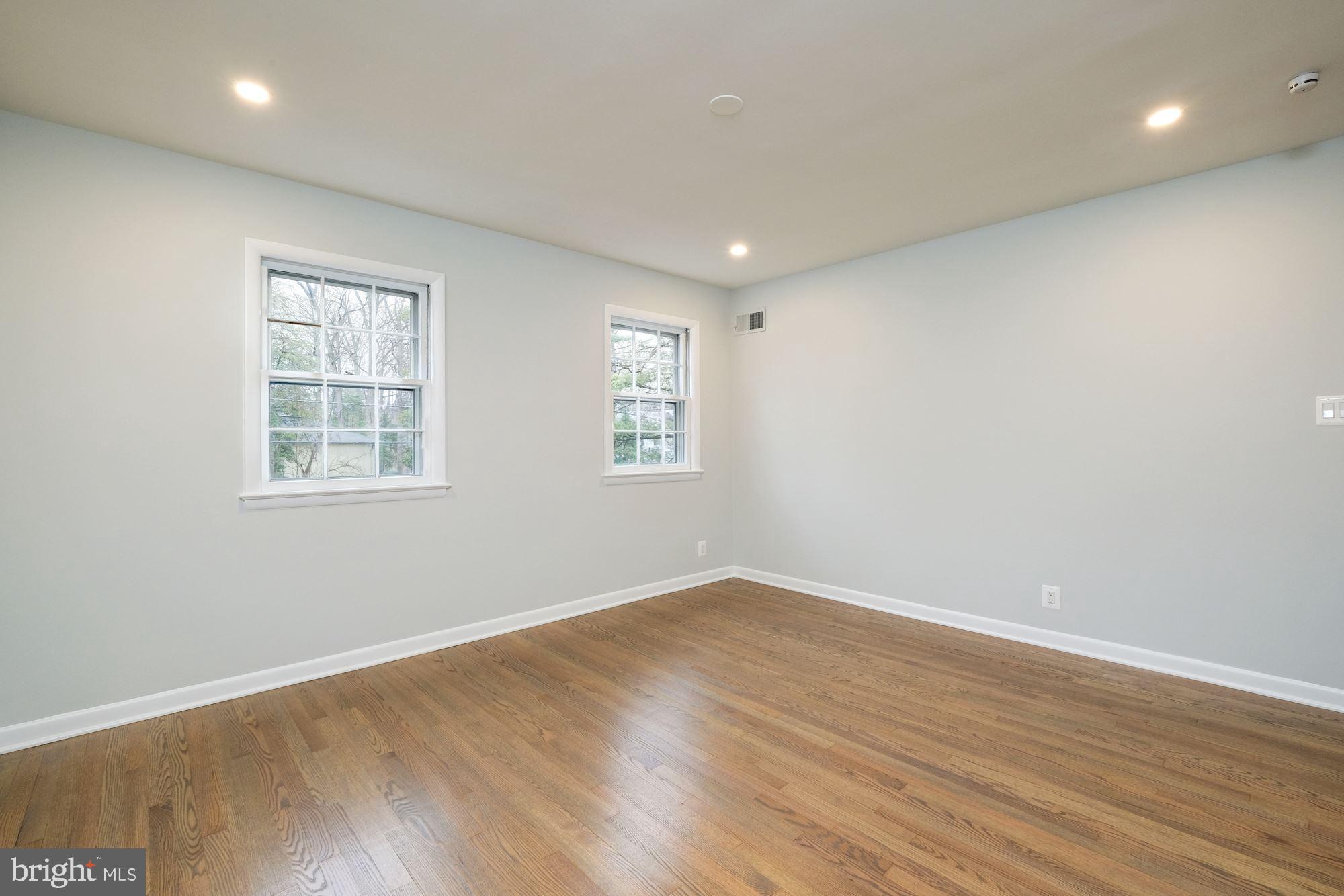 7440 Arrowood Road Bethesda, MD 20817 - Photo 62 of 79 a view of empty room with wooden floor and fan