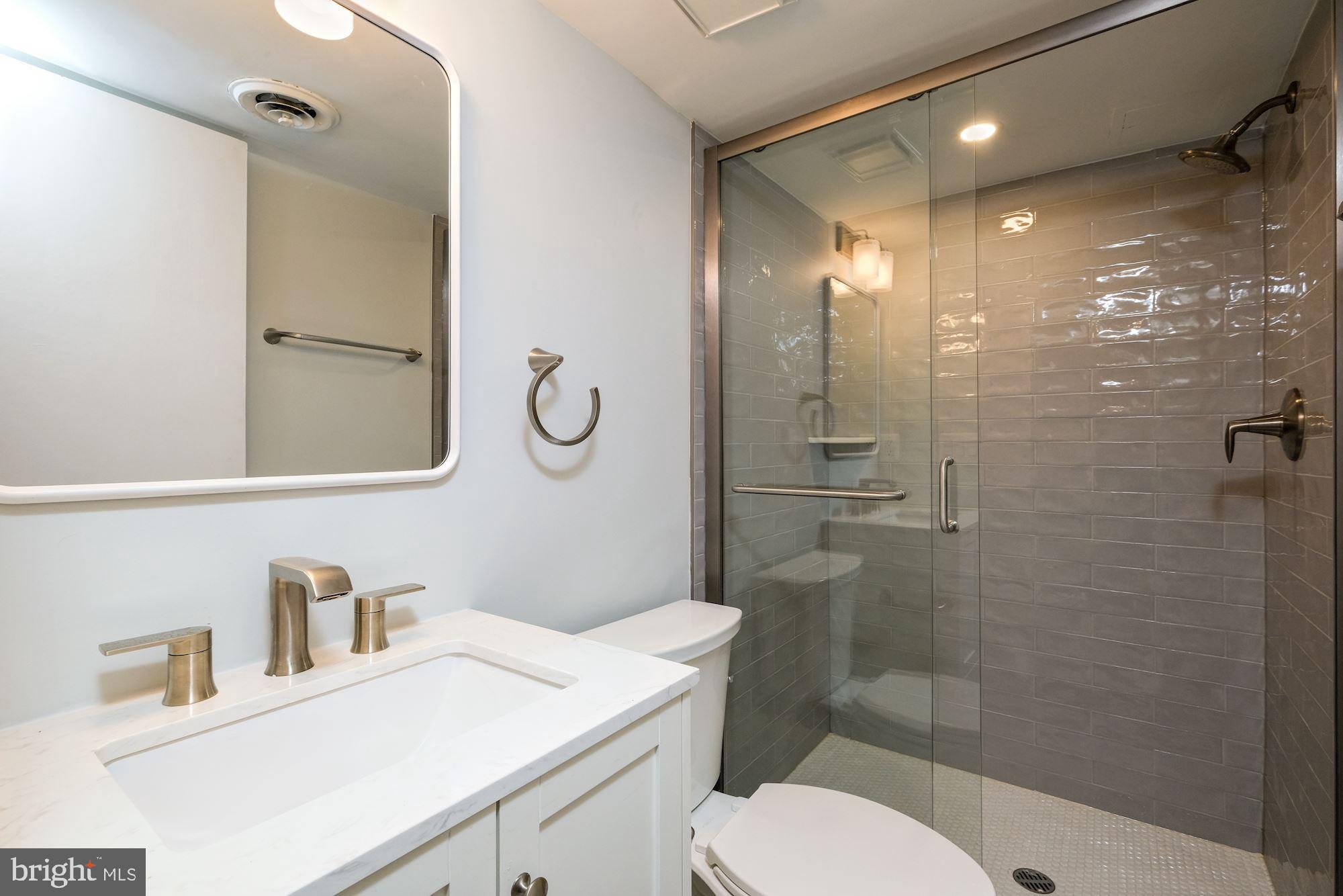 7440 Arrowood Road Bethesda, MD 20817 - Photo 66 of 79 a bathroom with a sink a toilet and shower