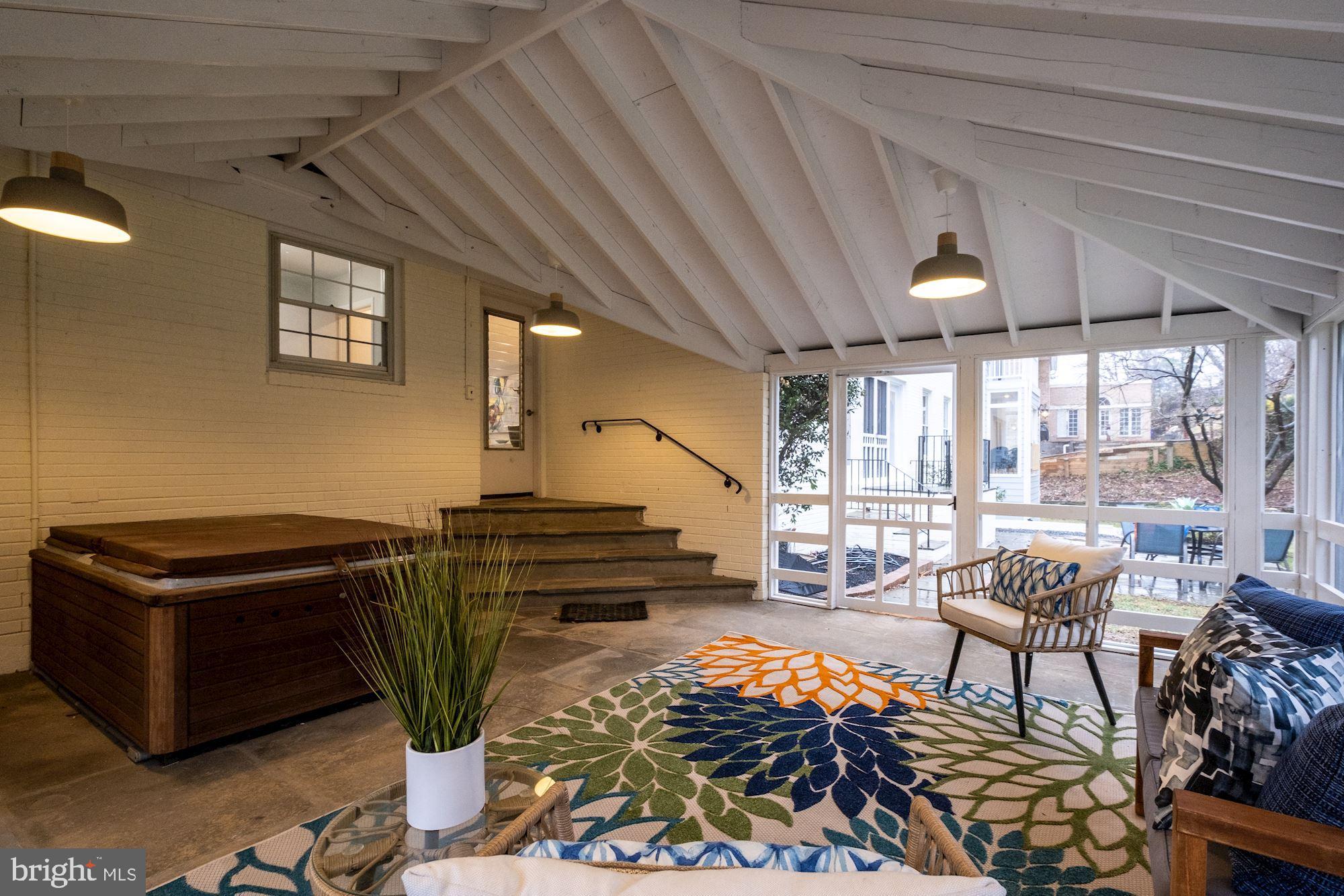 7440 Arrowood Road Bethesda, MD 20817 - Photo 71 of 79 a living room with furniture a wooden floor and a window