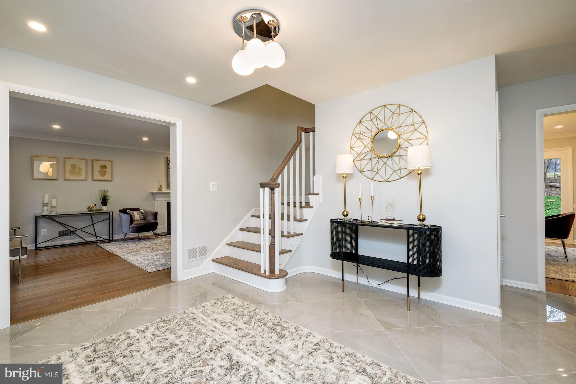 7440 Arrowood Road Bethesda, MD 20817 - Photo 9 of 79 a view of a livingroom with wooden floor and a chandelier