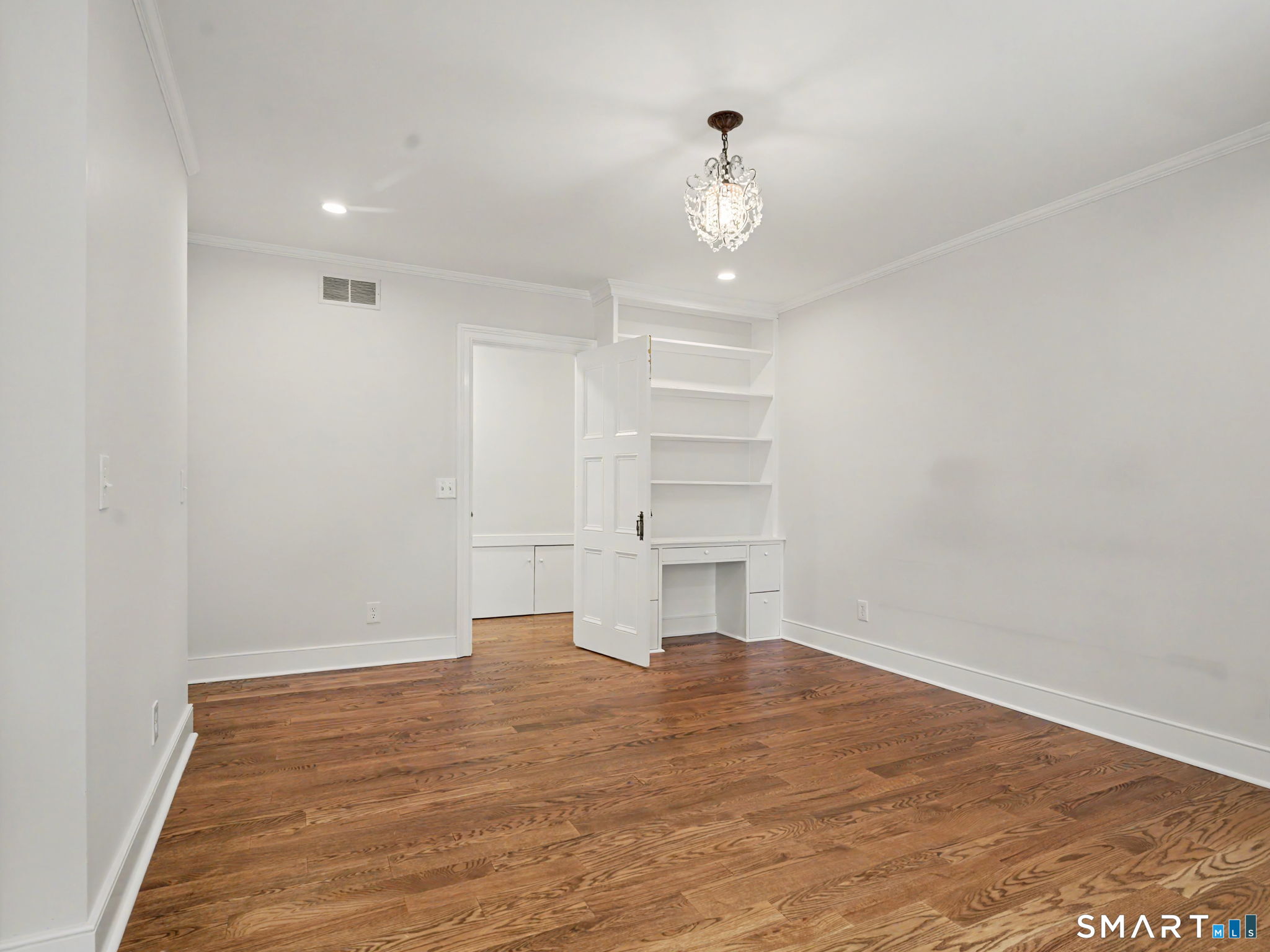 530 Roxbury Road Stamford, CT 06902 - Photo 27 of 40 Spacious bedroom with built-in shelving and desk.