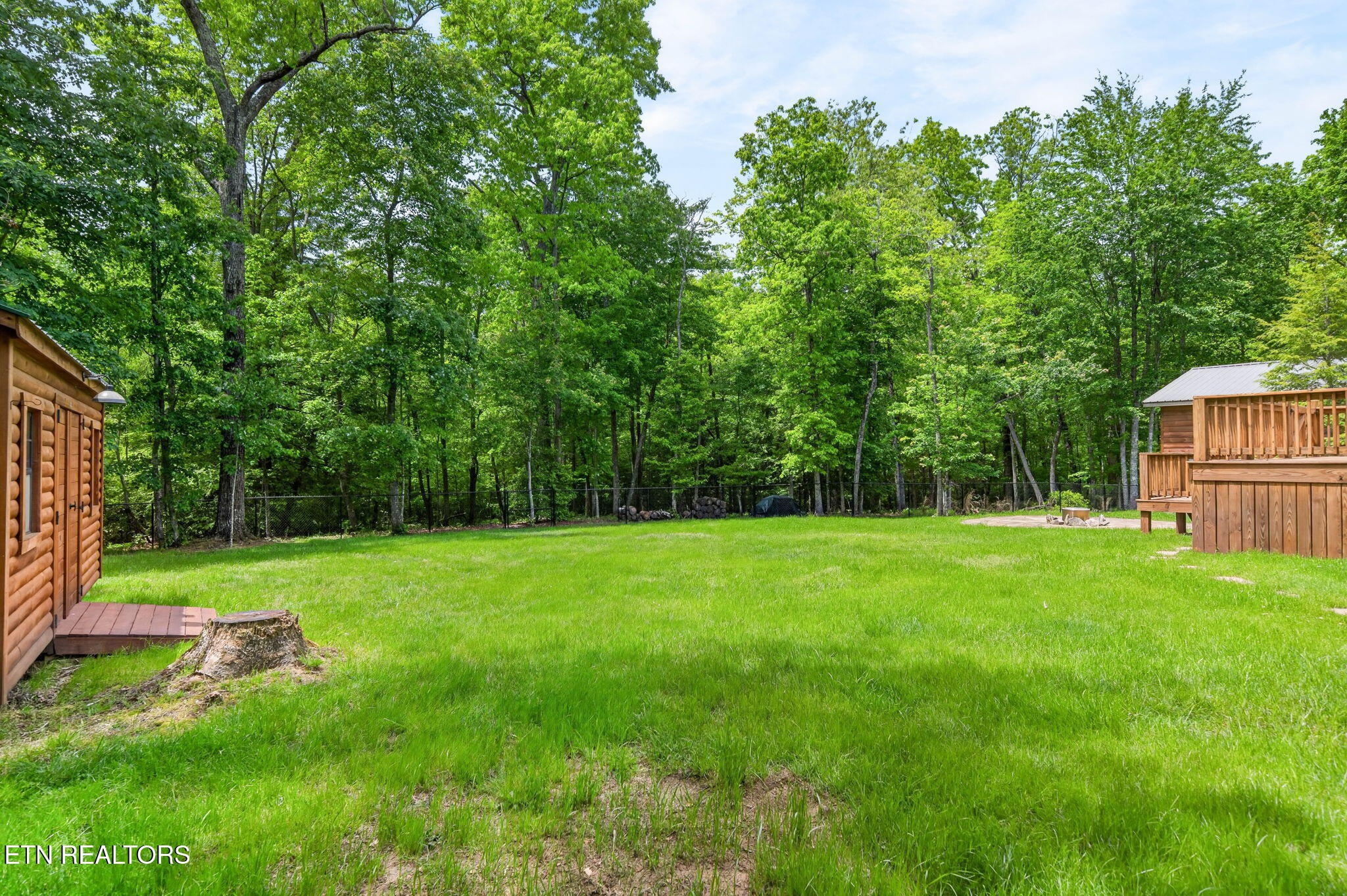 704 White Oak Road Monterey, TN 38574 - Photo 20 of 60 a view of a backyard with a garden and entertaining space