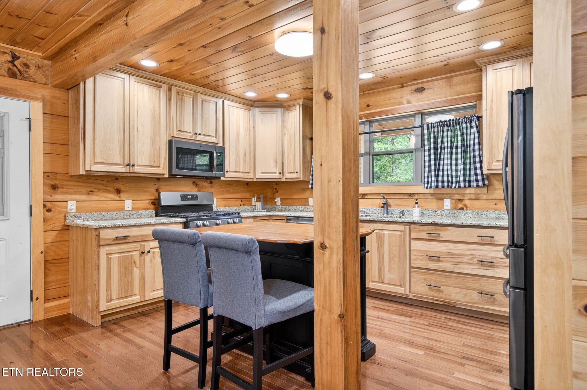 704 White Oak Road Monterey, TN 38574 - Photo 40 of 60 a kitchen with kitchen island a stove a sink and a refrigerator