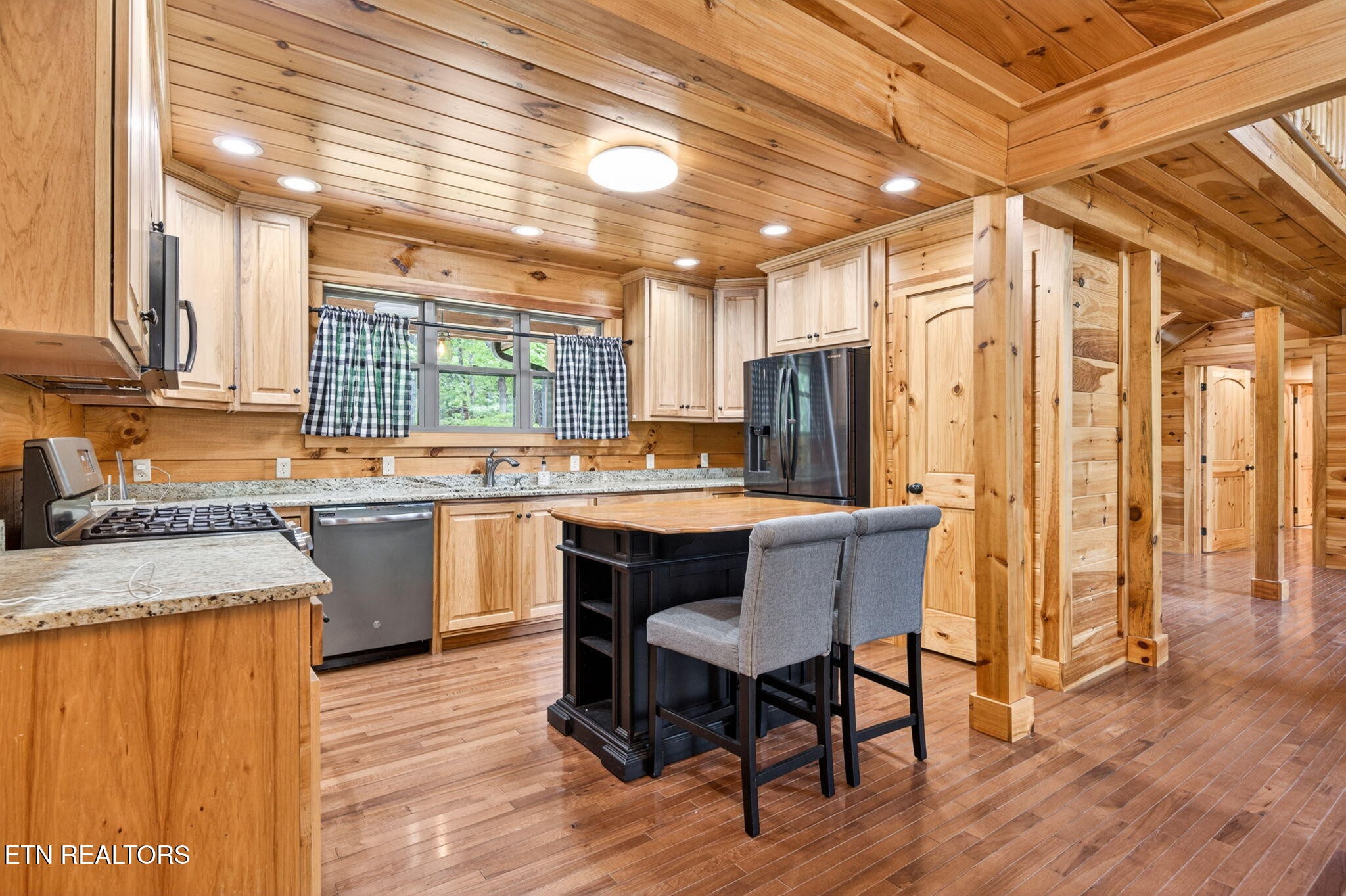 704 White Oak Road Monterey, TN 38574 - Photo 41 of 60 a kitchen with a table chairs refrigerator and cabinets