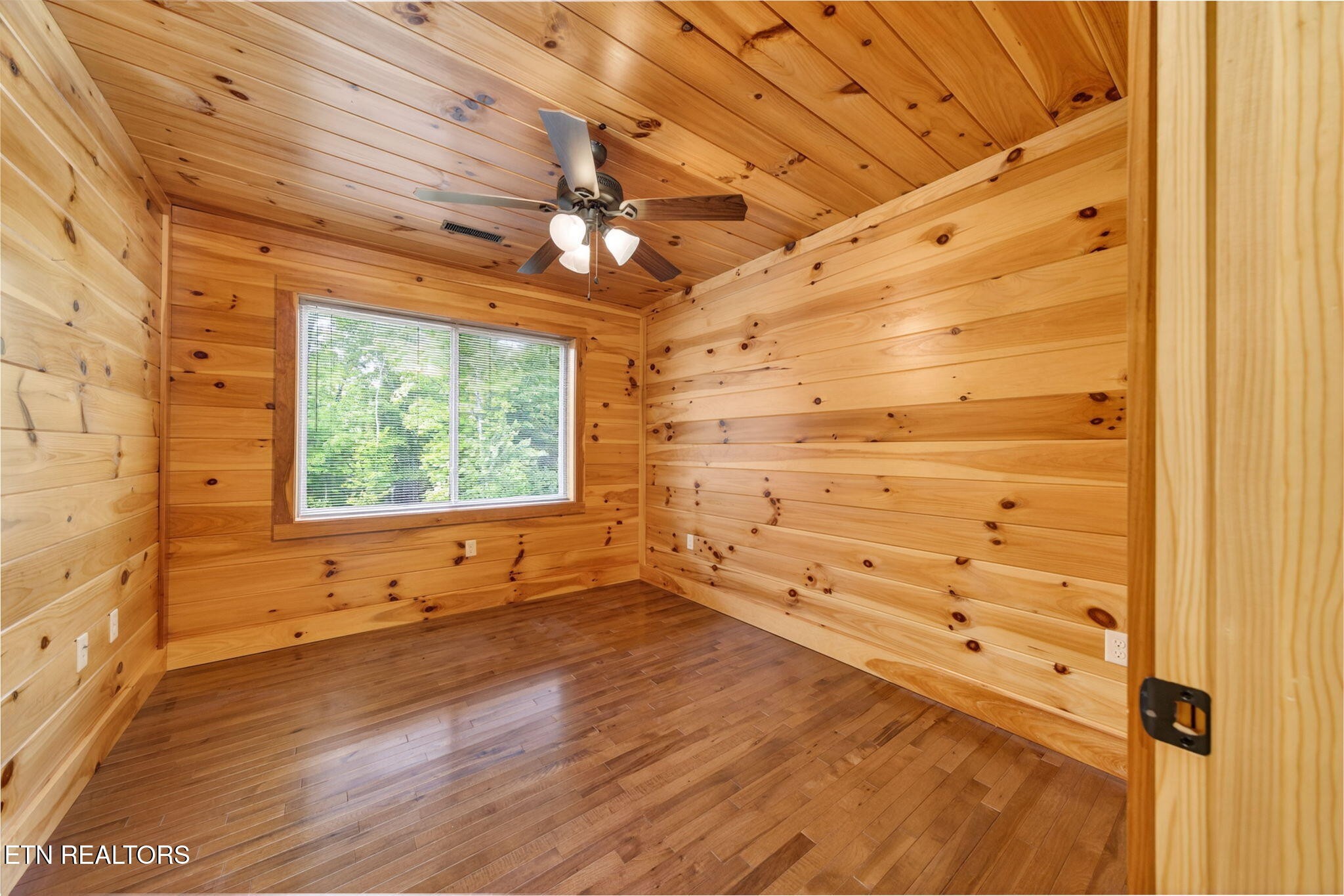 704 White Oak Road Monterey, TN 38574 - Photo 58 of 60 a view of an empty room with a window and wooden floor