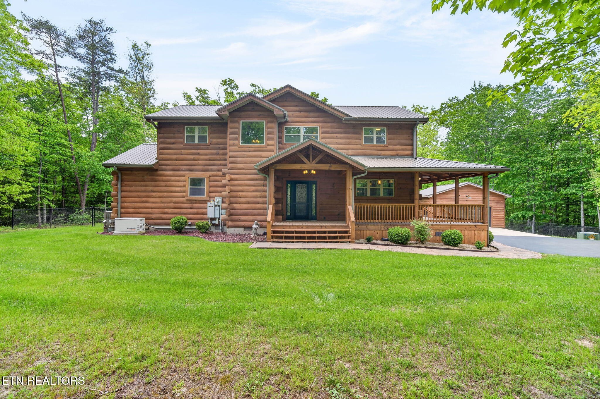 704 White Oak Road Monterey, TN 38574 - Photo 10 of 60 a front view of a house with a garden