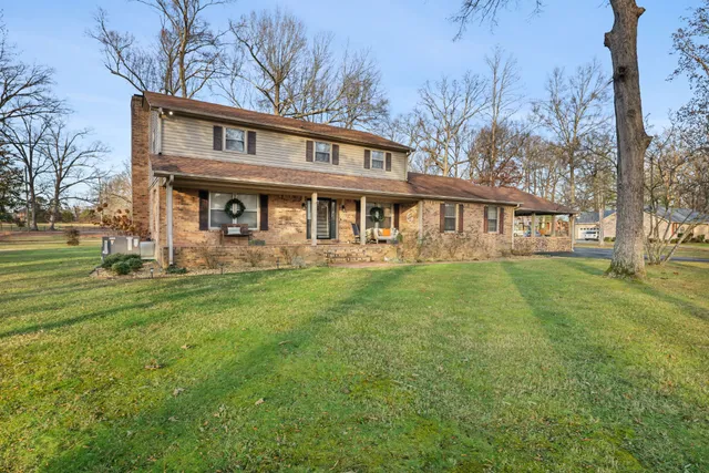a view of a house with a yard table and chairs