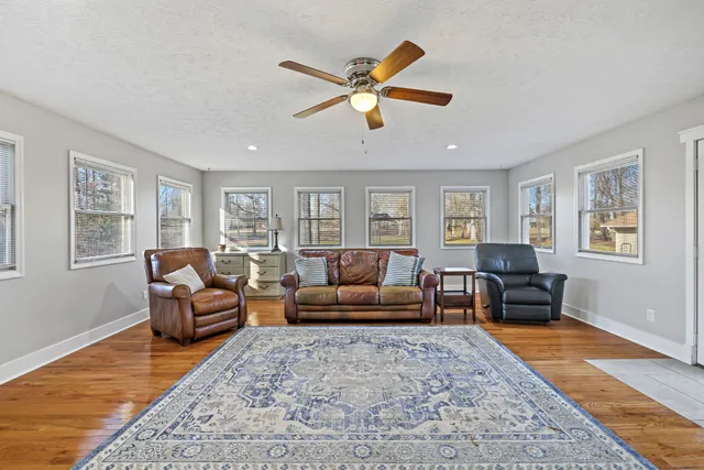 a living room with furniture and a wooden floor