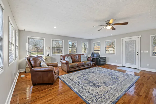 a living room with furniture and wooden floor