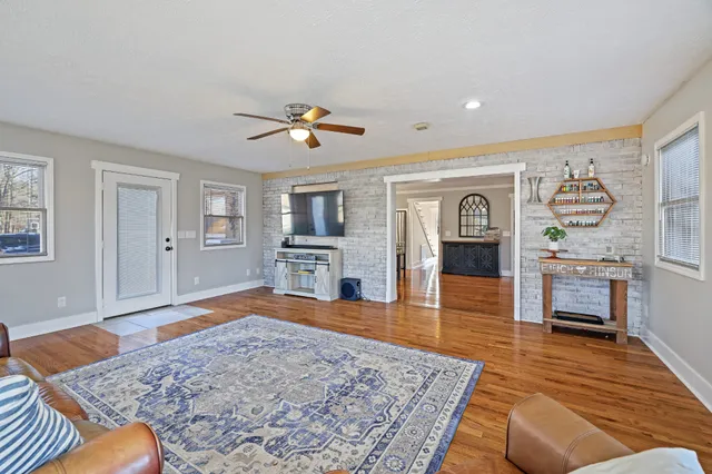 a living room with furniture and wooden floor