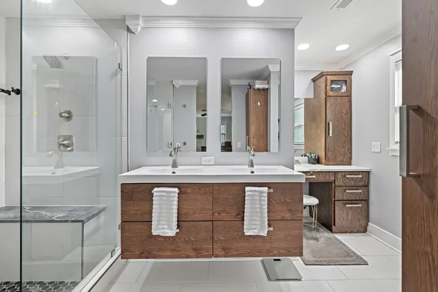 a large bathroom with a double vanity sink a mirror and a bathtub