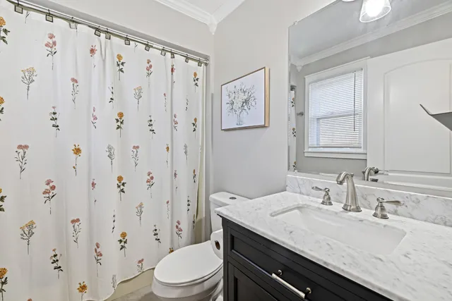 a bathroom with a granite countertop sink a toilet and a mirror