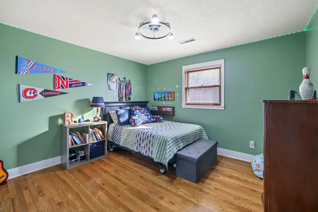 a bedroom with a bed and a chandelier