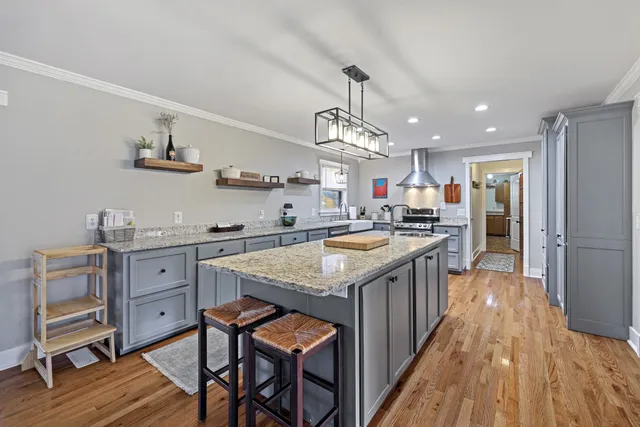 a kitchen with cabinets and wooden floor