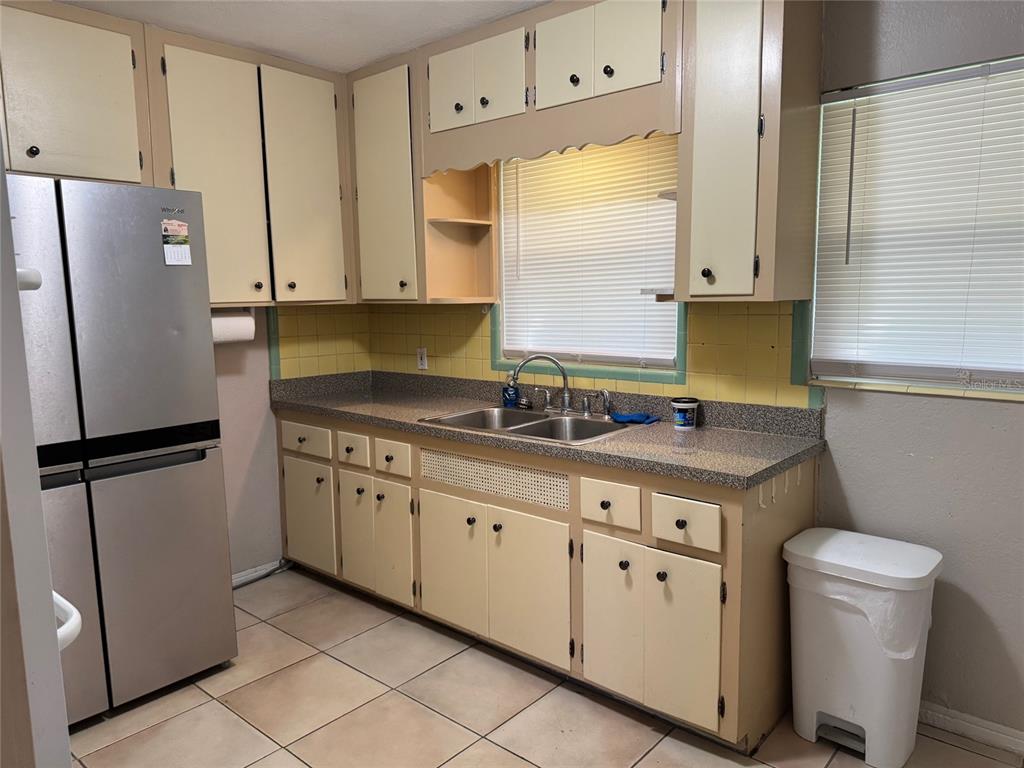 2500 14th Avenue North St. Petersburg, FL 33713 - Photo 14 of 27 a kitchen with stainless steel appliances granite countertop a refrigerator a sink and white cabinets