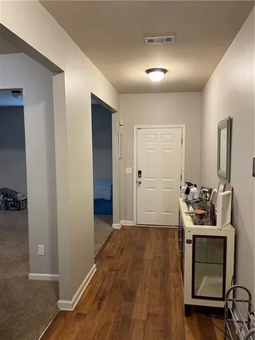 a view of a livingroom with a furniture wooden floor and a ceiling fan