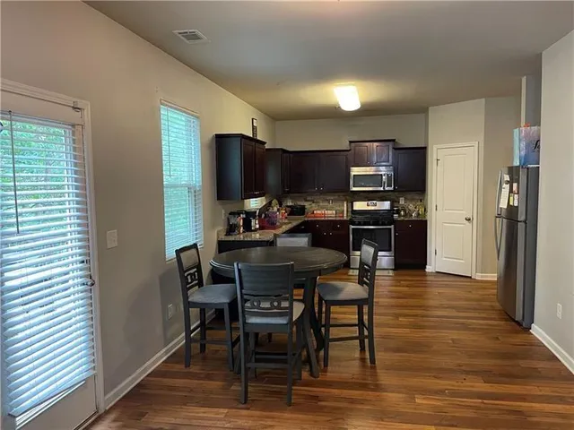 a view of a dining room with furniture and wooden floor