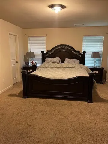a bedroom with a bed and window