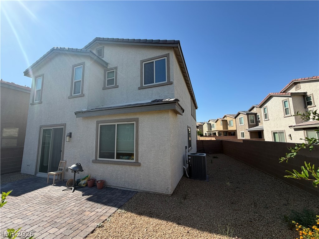 3228 Azalea Ridge Court Henderson, NV 89052 - Photo 27 of 28 A private paved patio complements this modern home's exterior, offering ample space for outdoor relaxation.