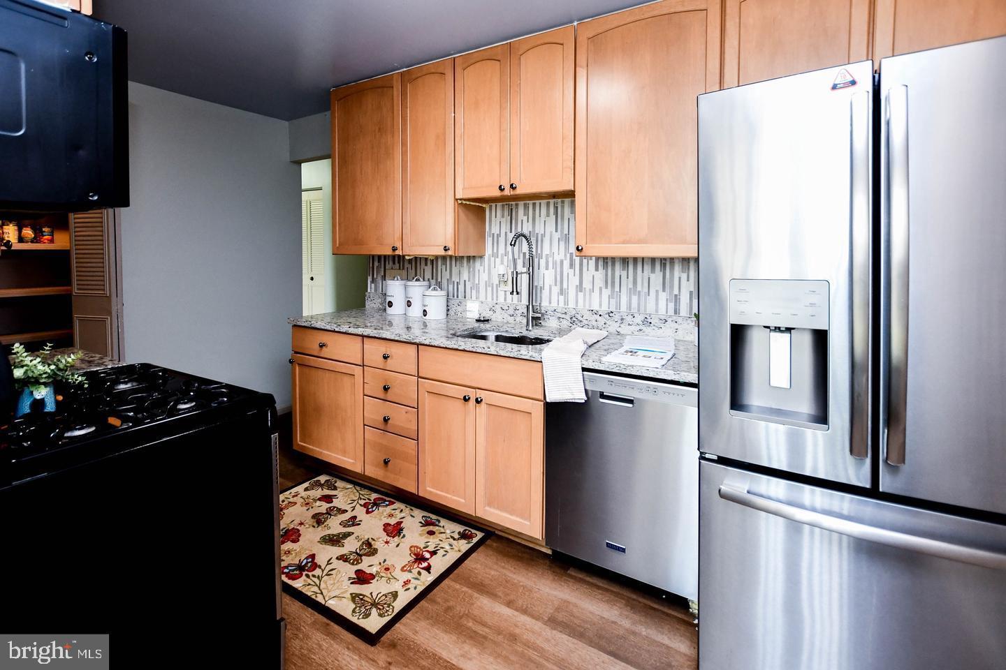 3319 Huntley Square Drive, Unit A Temple Hills, MD 20748 - Photo 6 of 17 a kitchen with stainless steel appliances a refrigerator stove and sink