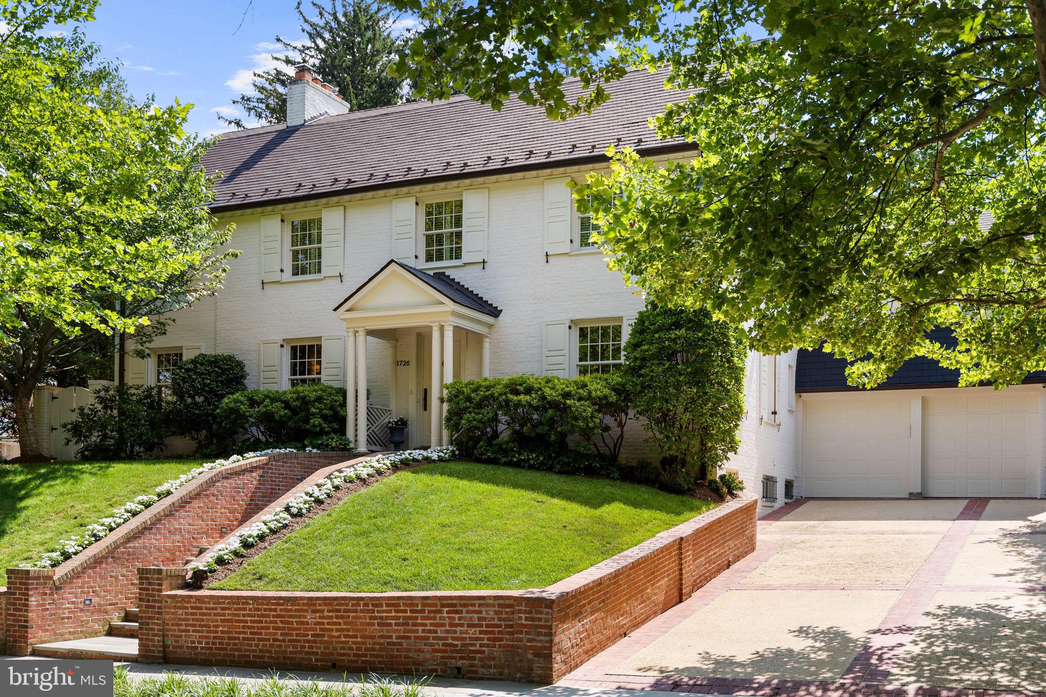 1726 Hoban Road Northwest Washington, DC 20007 - Photo 2 of 39 a front view of a house with a yard