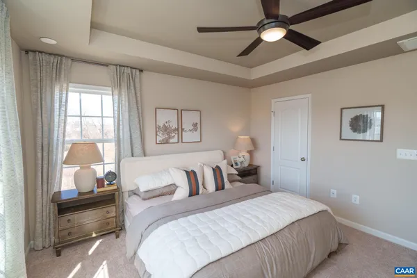 a bedroom with bed and a chandelier