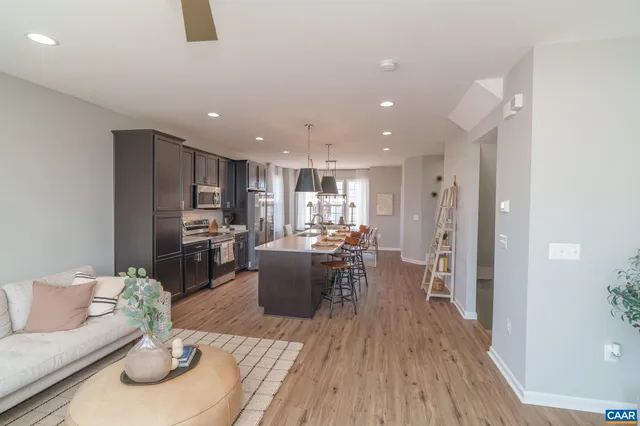 a living room with lots of furniture and kitchen view