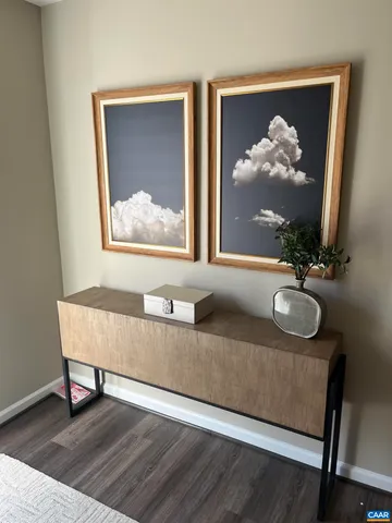 a living room with furniture and a painting on the wall
