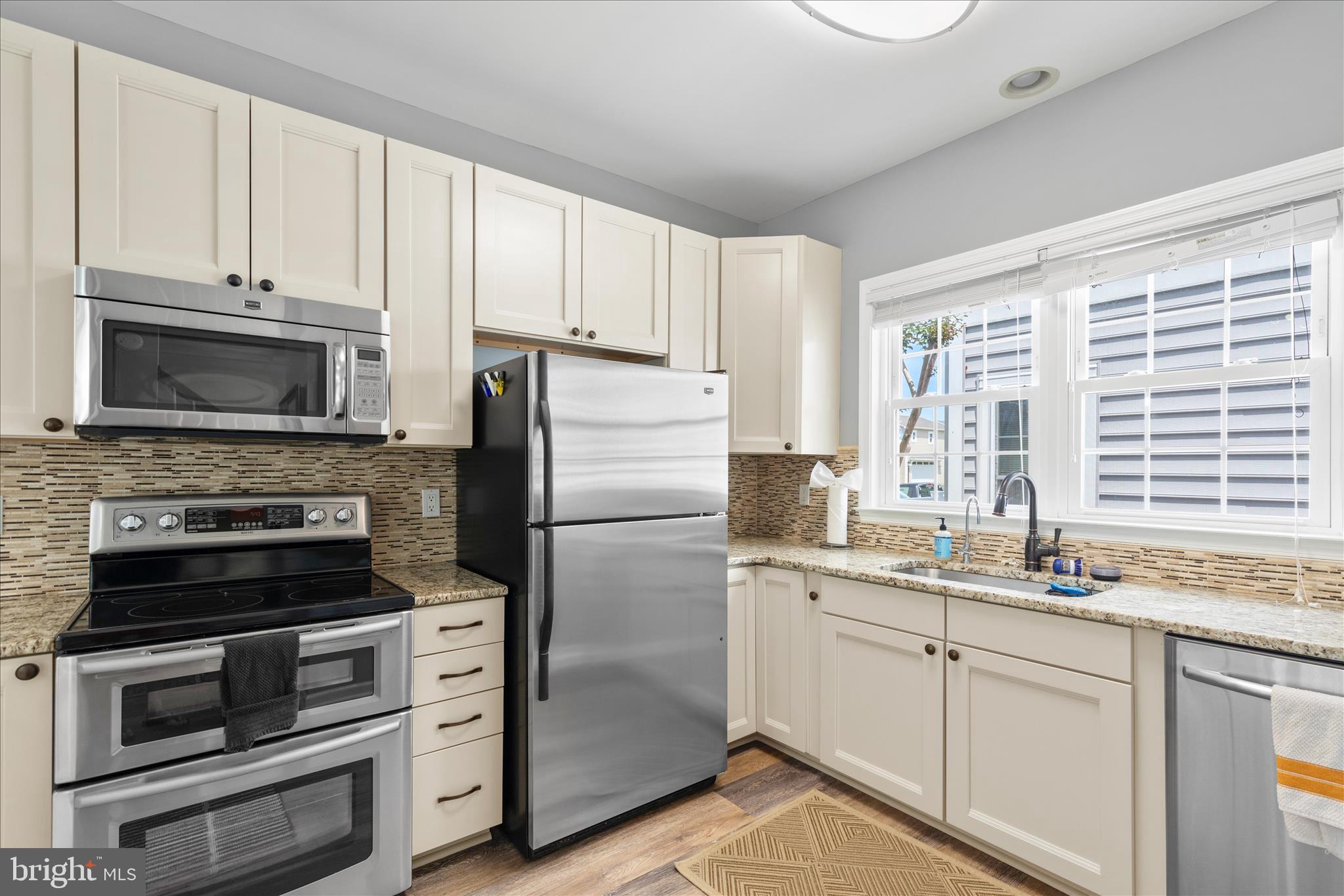 9739 Golf Course Road, Unit D102 Ocean City, MD 21842 - Photo 18 of 78 a kitchen with appliances a sink and cabinets