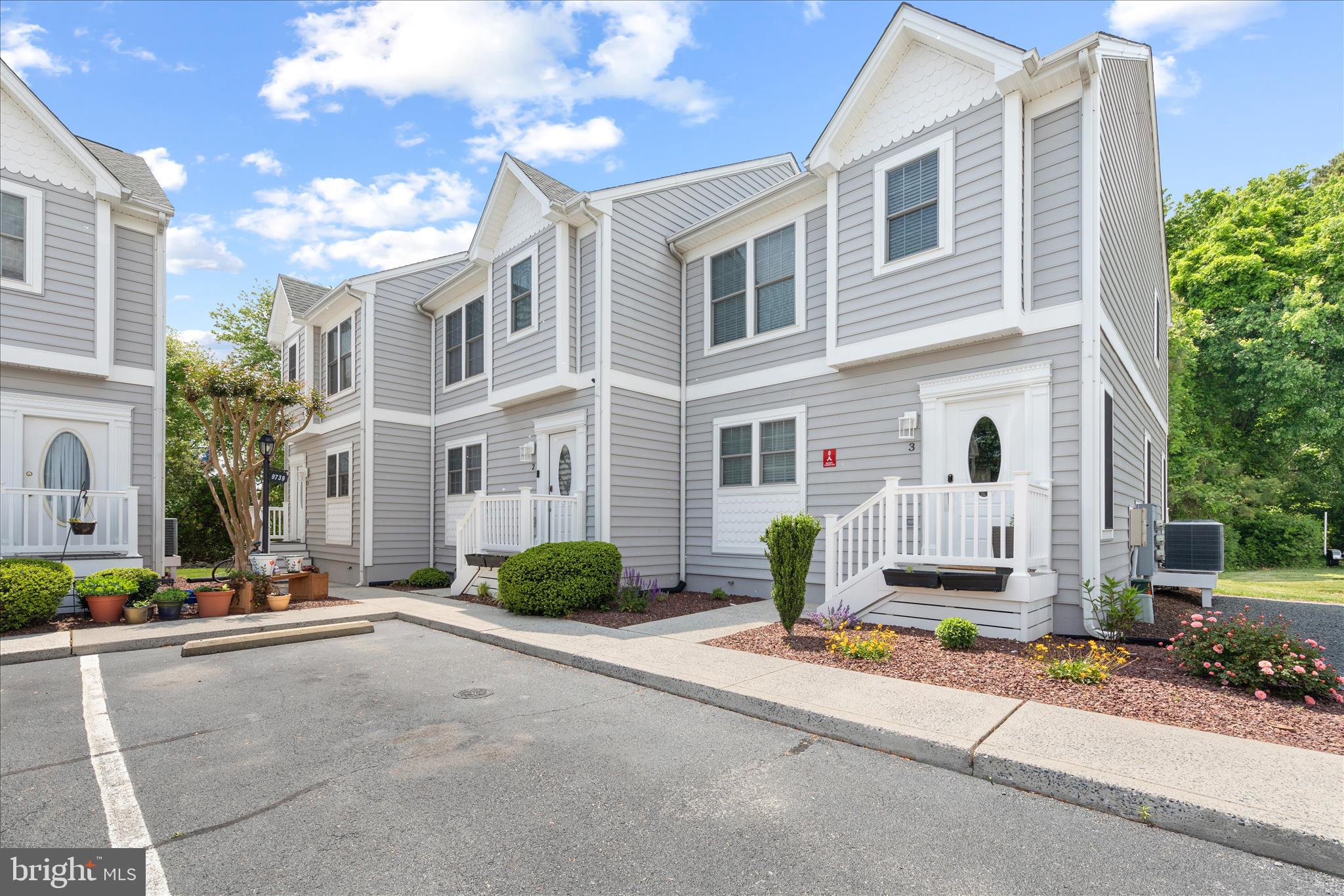 9739 Golf Course Road, Unit D102 Ocean City, MD 21842 - Photo 2 of 78 a front view of a building with sitting area