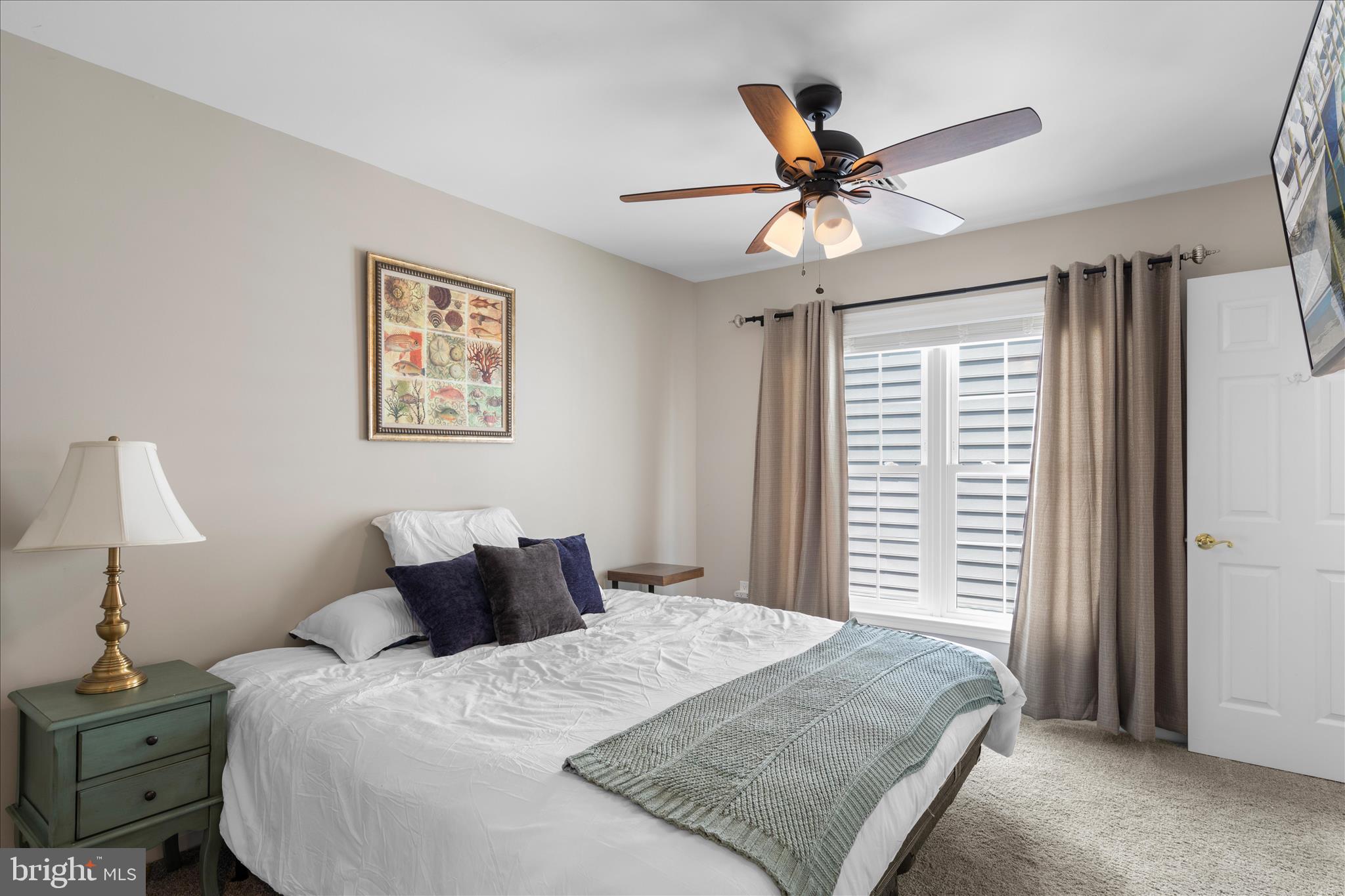 9739 Golf Course Road, Unit D102 Ocean City, MD 21842 - Photo 28 of 78 a bedroom with a bed and a chandelier
