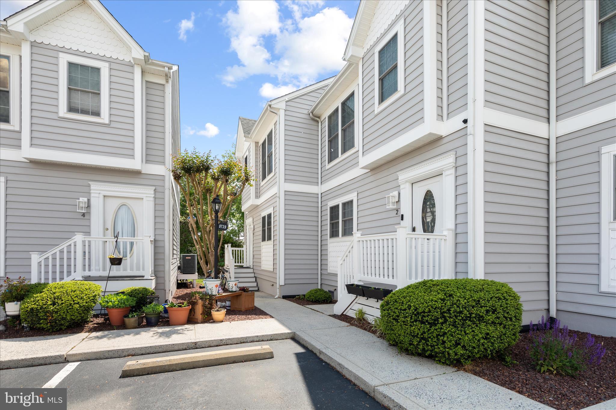 9739 Golf Course Road, Unit D102 Ocean City, MD 21842 - Photo 3 of 78 a front view of a house with a garden