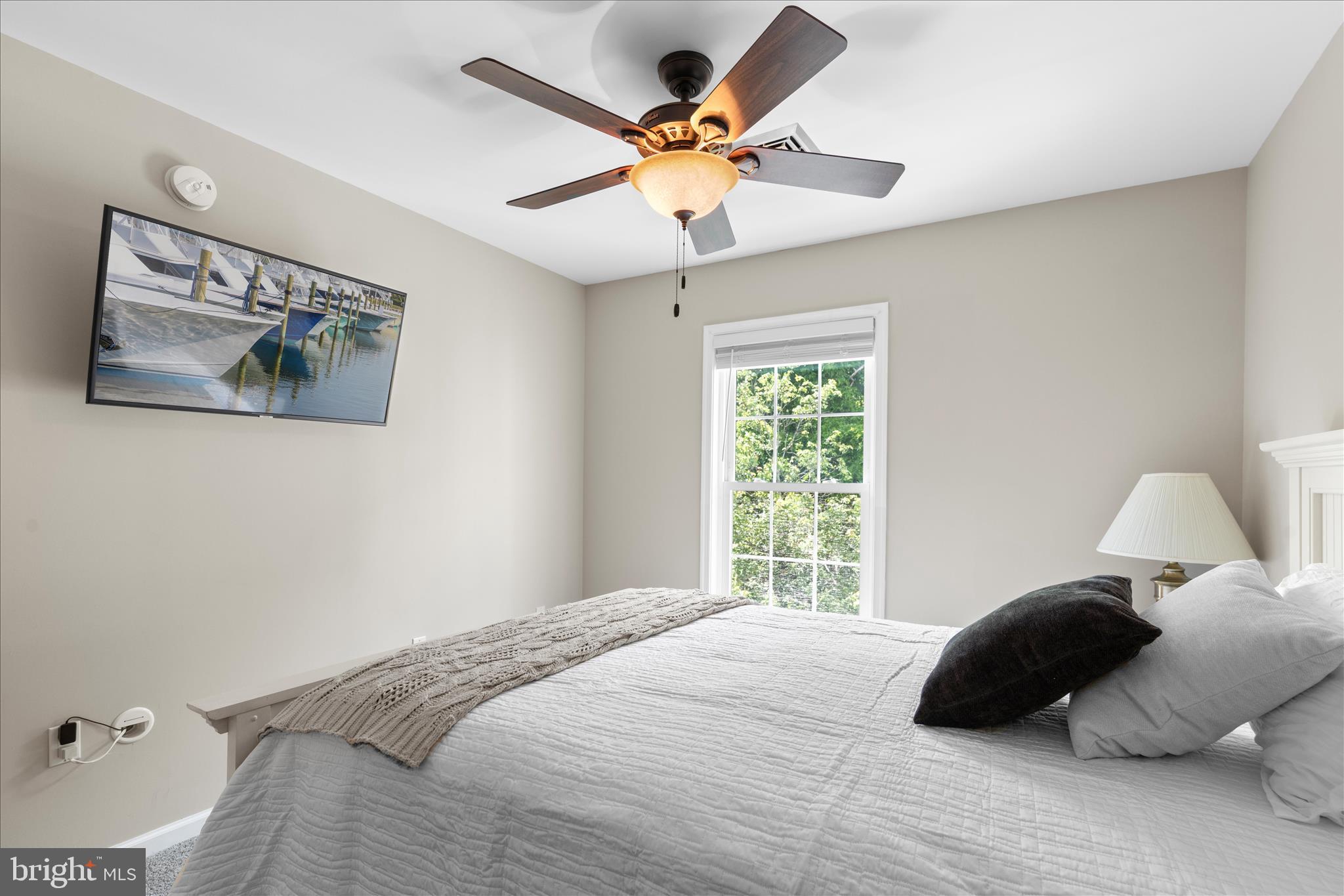 9739 Golf Course Road, Unit D102 Ocean City, MD 21842 - Photo 44 of 78 a bedroom with a bed window and a ceiling fan