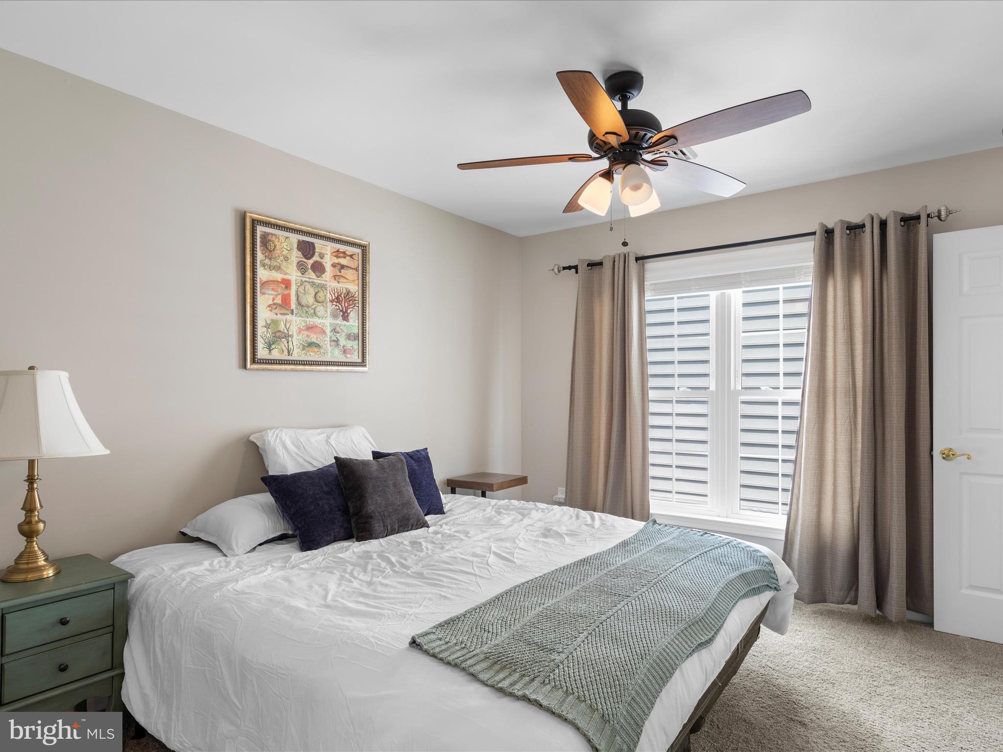 9739 Golf Course Road, Unit D102 Ocean City, MD 21842 - Photo 55 of 78 a bedroom with a bed and a chandelier