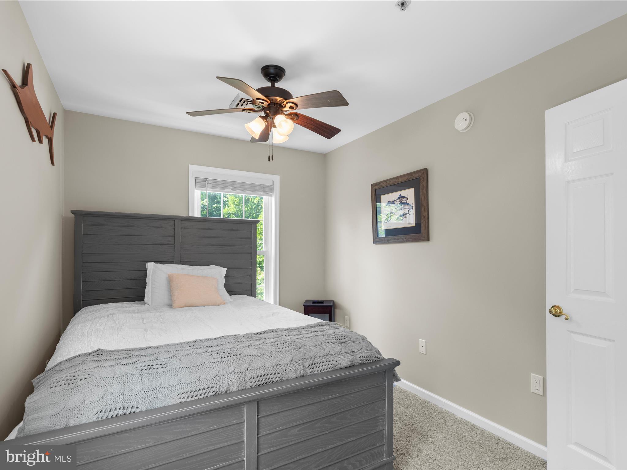 9739 Golf Course Road, Unit D102 Ocean City, MD 21842 - Photo 63 of 78 a bedroom with a large bed and a ceiling fan