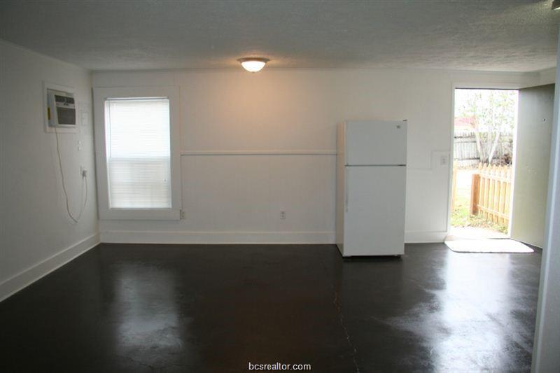 3109 Maloney Avenue, Unit A Bryan, TX 77801 - Photo 4 of 13 a view of a room with wooden floor and a window
