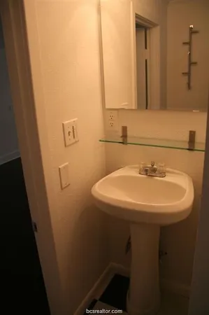 a bathroom with a sink a toilet and mirror