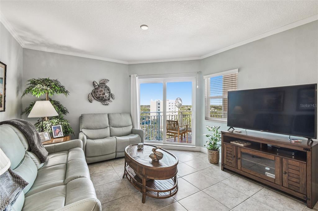 4516 Seagull Drive, Unit 807 New Port Richey, FL 34652 - Photo 17 of 100 a living room with furniture and a flat screen tv