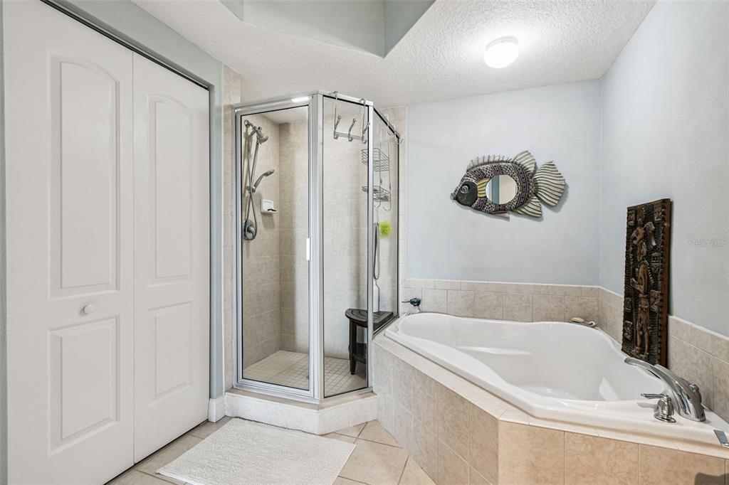 4516 Seagull Drive, Unit 807 New Port Richey, FL 34652 - Photo 30 of 100 a bathroom with a tub a sink and glass door