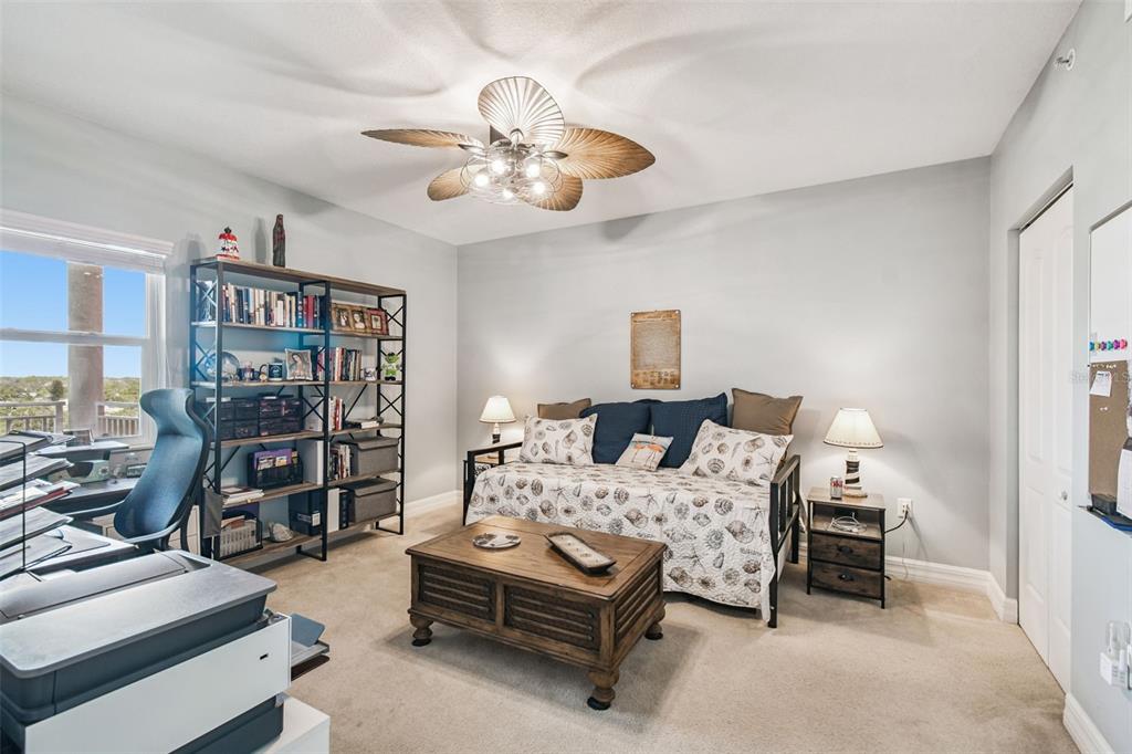 4516 Seagull Drive, Unit 807 New Port Richey, FL 34652 - Photo 32 of 100 a bedroom with bed and a chandelier