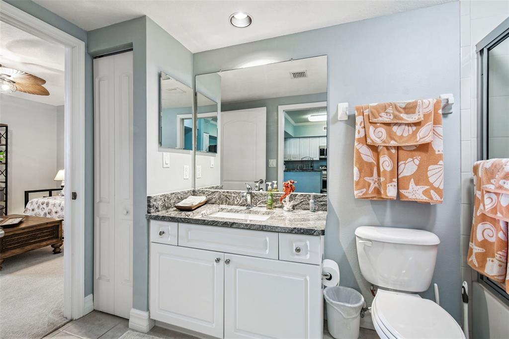 4516 Seagull Drive, Unit 807 New Port Richey, FL 34652 - Photo 35 of 100 a bathroom with a toilet sink and mirror