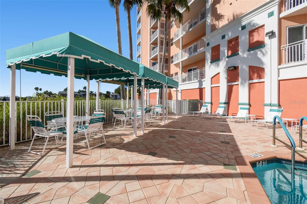 4516 Seagull Drive, Unit 807 New Port Richey, FL 34652 - Photo 44 of 100 a view of a patio with a table and chairs under an umbrella