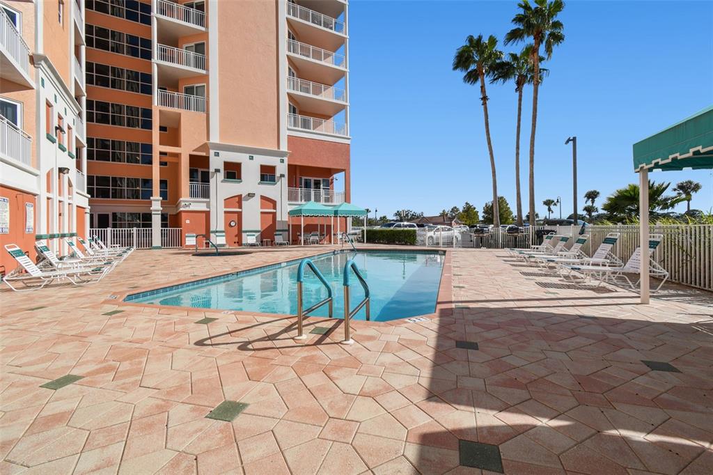 4516 Seagull Drive, Unit 807 New Port Richey, FL 34652 - Photo 45 of 100 a view of a swimming pool with a lounge chairs