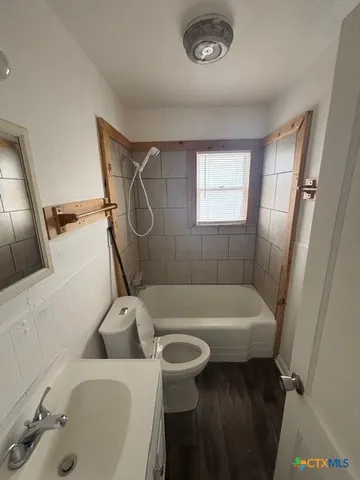 a bathroom with a sink a toilet and a tub
