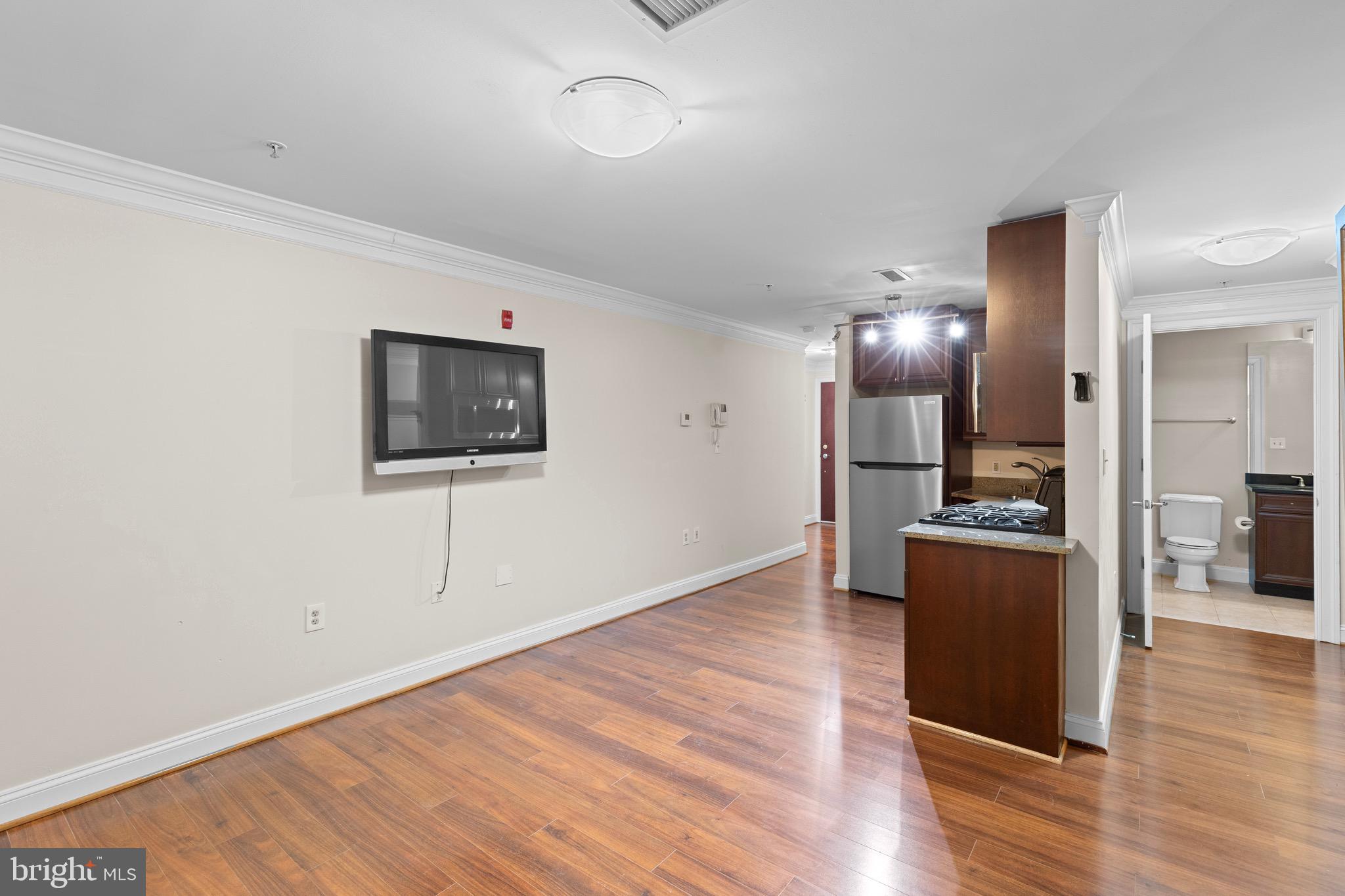 1210 R Street Northwest, Unit B1 Washington, DC 20009 - Photo 10 of 15 a view of a refrigerator in kitchen and wooden floor